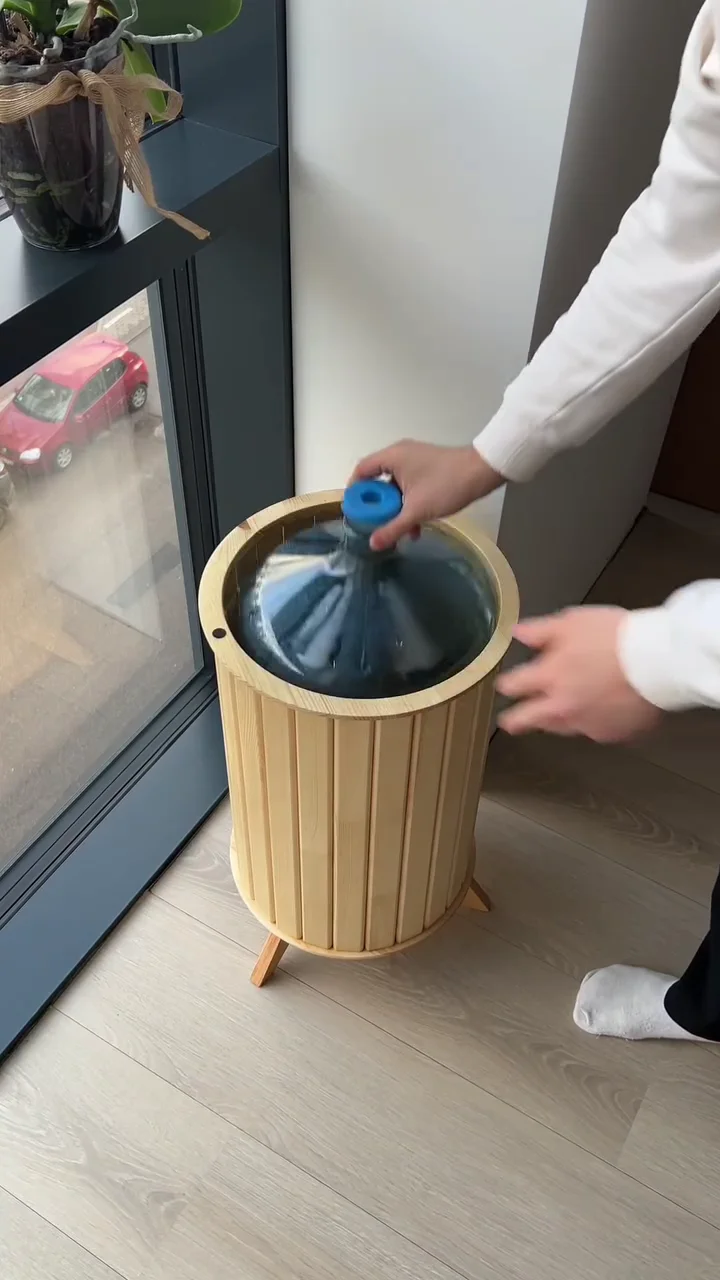 fluted wood furniture piece is the Fjord Deco water dispenser table, designed to conceal a standard 5-gallon water bottle within its base